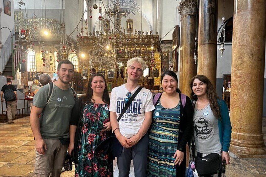 Euphoric participants exploring the Nativity Church, embracing the magic of a Bethlehem half-day tour, as history and spirituality come alive in the heart of the Holy Land.