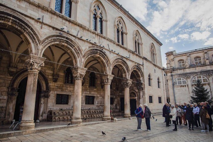 Travelers admire the regal arches of Dubrovnik's Rector's Palace, which featured briefly in Game of Thrones Season 2.