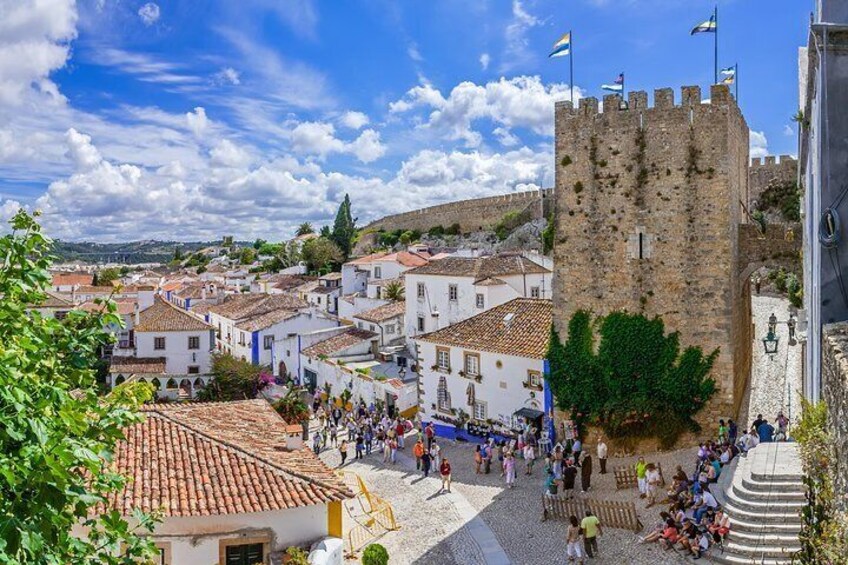 Óbidos is a medieval town with cobblestone streets and flower-bedecked, whitewashed houses