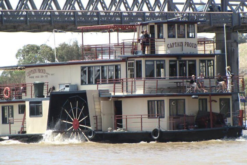 Captain Proud cruising under the bridge