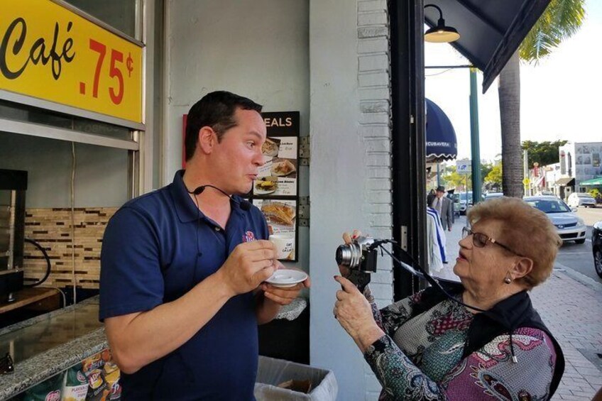 Guest taking photo of guide as he explains tradition of Cuban coffee 