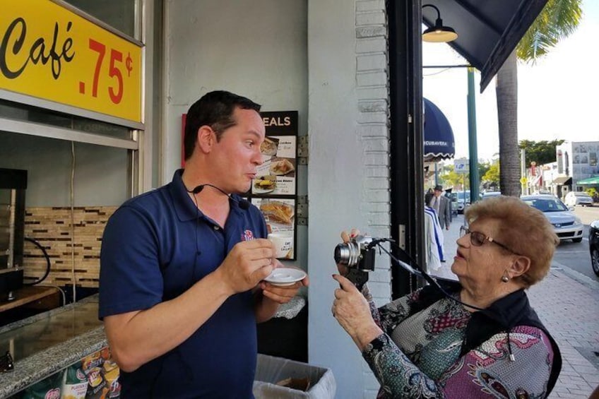 Guest taking photo of guide as he explains tradition of Cuban coffee