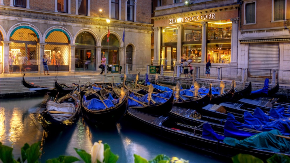 Gondolas parked in the water next to the Hard Rock Cafe in Venice Italy