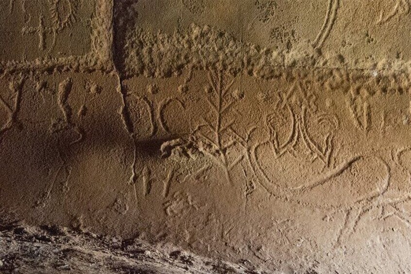 Images were carved into the rock by the young girls that were secluded for months in this cave