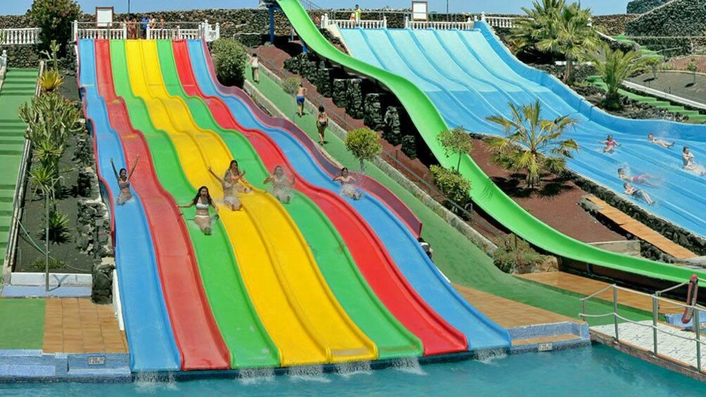 girls going down a waterslide next to one another in West Africa