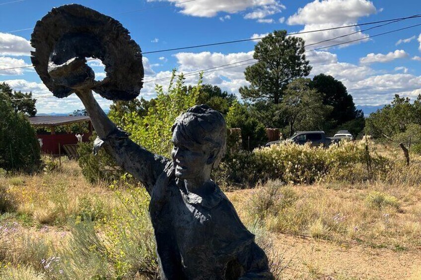 Sculpture of a young boy greeting the merchants arriving on the Santa Fe Trail.
