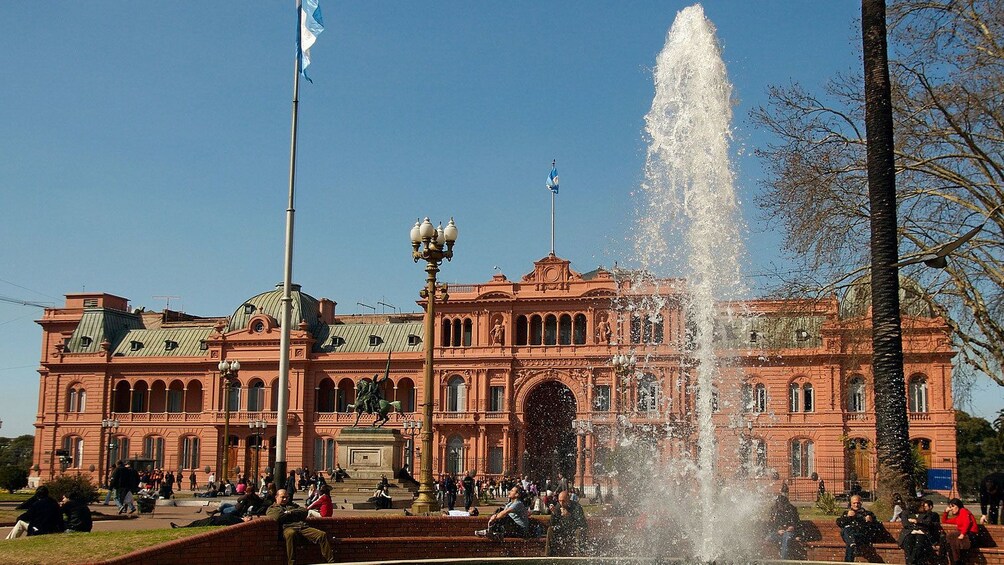 water fountain outside an old red building in Argentina
