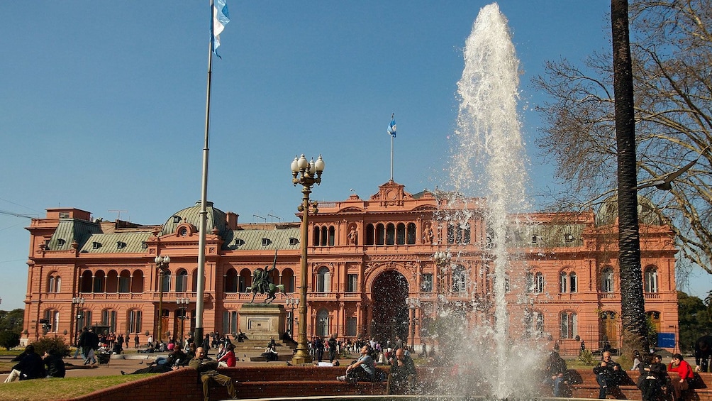 water fountain outside an old red building in Argentina