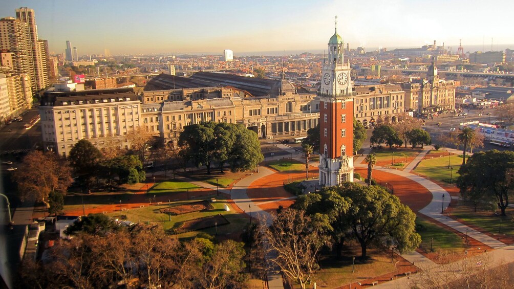 a clock tower at the center of a park in Argentina