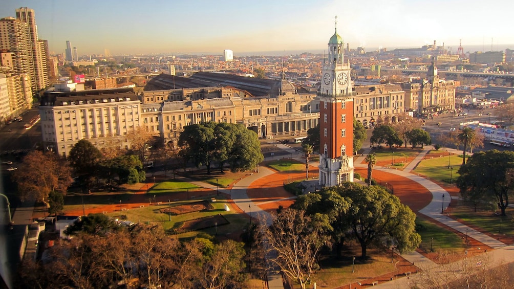 a clock tower at the center of a park in Argentina