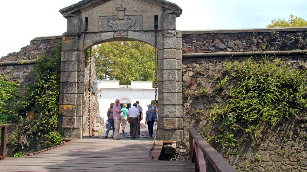 group walking across an old moat in Argentina