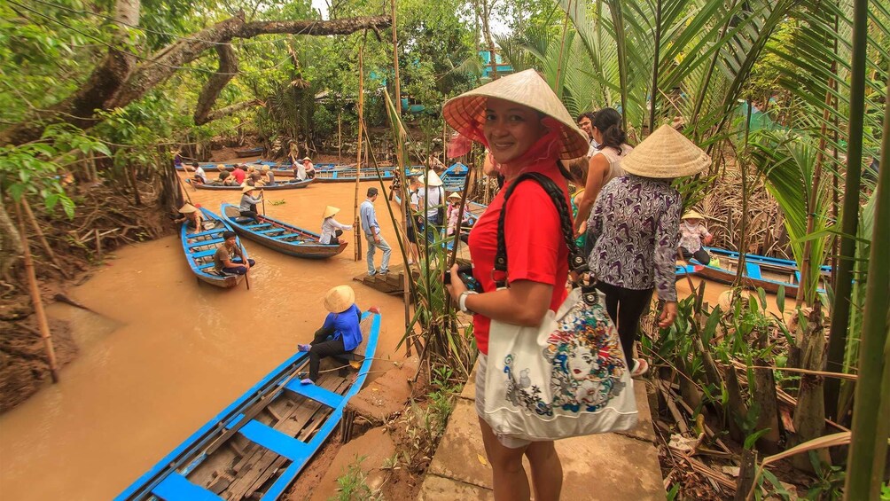 Tourists wearing straw hats getting ready for a river tour in Vietnam