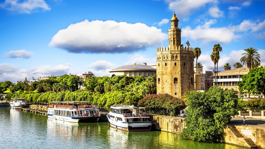 Landscape of Guadalquivir river area with several buildings in view.