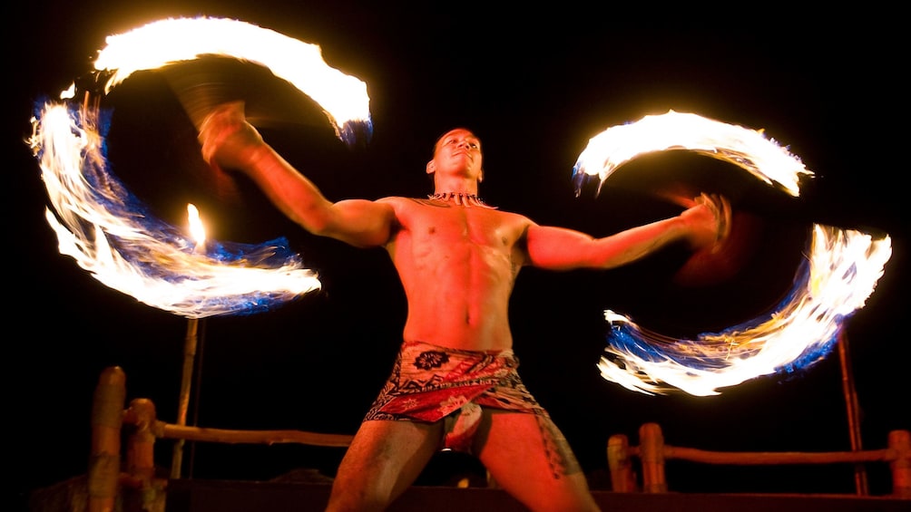 Male swing fire in the Te Au Moana Luau performance in Maui