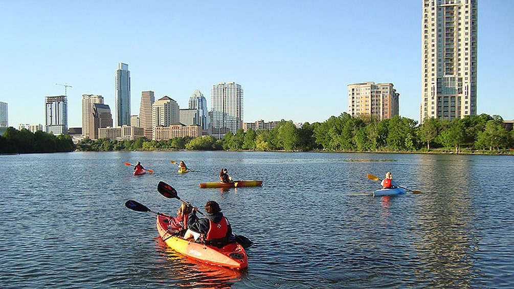 Several kayakers paddling through river in Austin