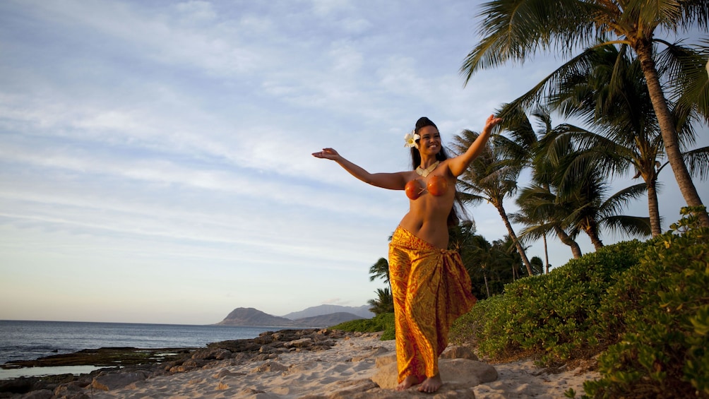 Lovely woman in orange dress on the beach in Oahu