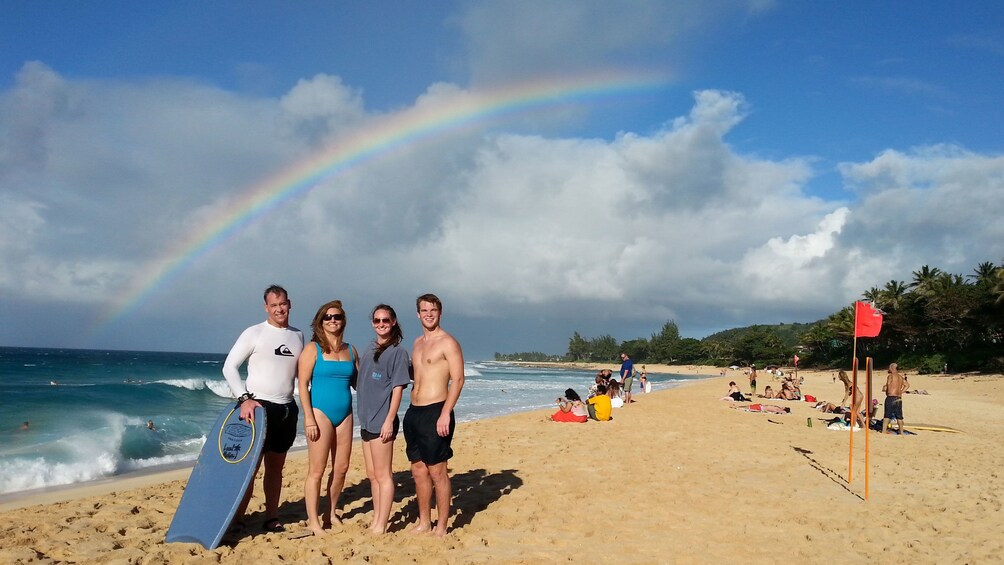 Family standing on beach in Oahu