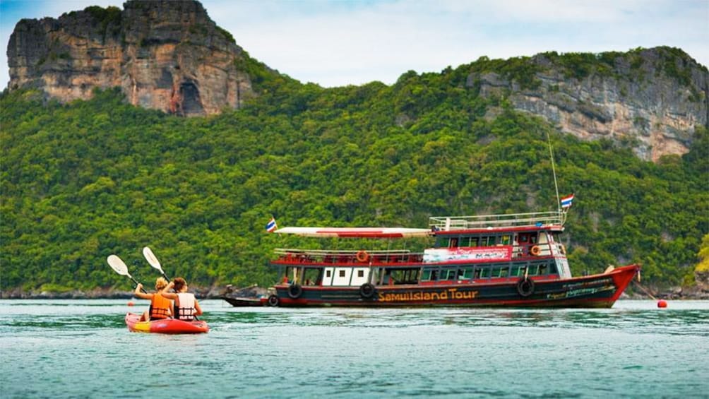 Women kayaking near a boat on Samui Island