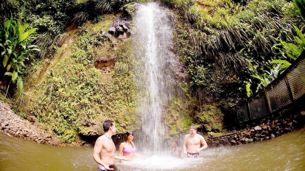 Guests swimming at a waterfall on the Soufriere Safari adventure