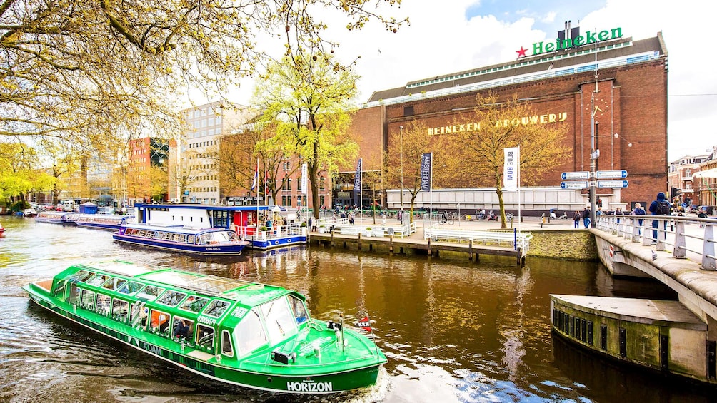 Canal tour boats in front of Heineken brewery in Amsterdam 