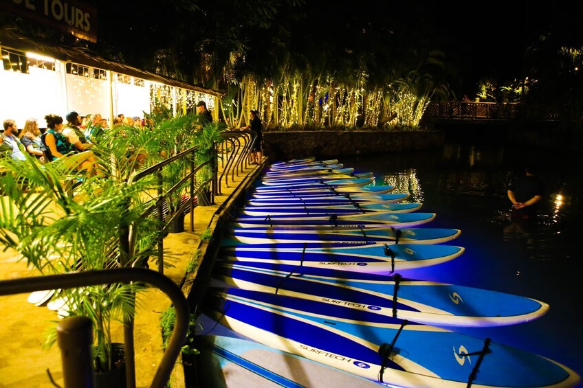 Photo of paddle boards lined up on a rack