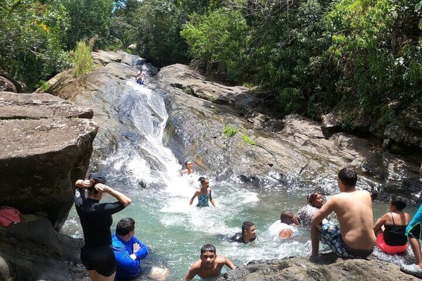 El Yunque Rainforest Natural Waterslide on a sunny Puerto Rico Day