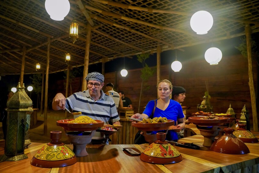 Red Dunes Quad Bike, Sandsurf, Camels & Arabian Buffet Dinner at Al Khayma
