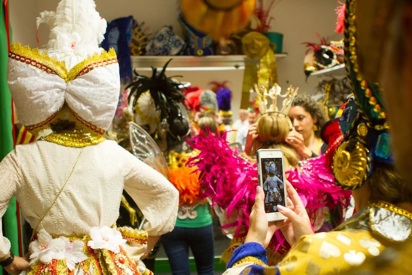 Tourists dress up in elaborate Carnaval costumes
