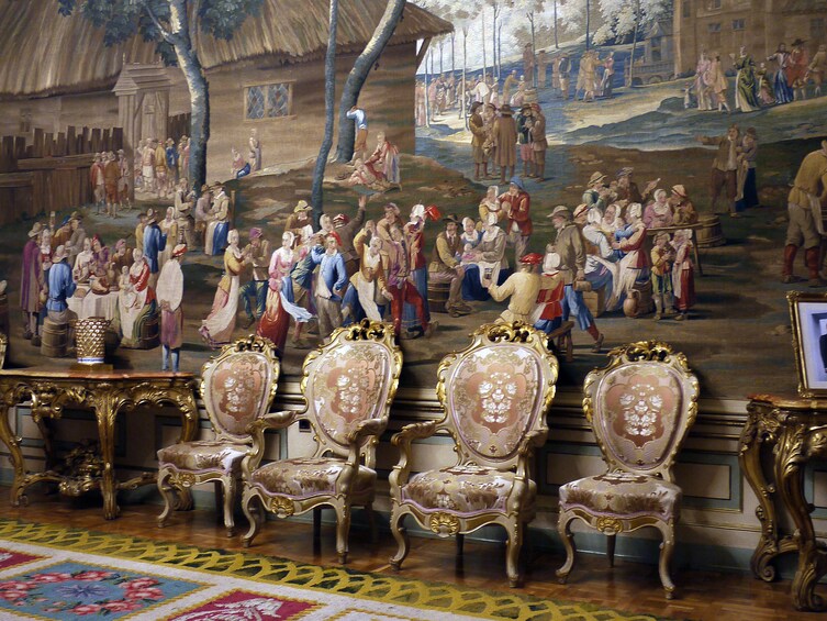 Chairs and paintings inside the Royal Palace of Madrid
