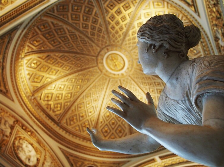 Marble statue and gold ceiling of the Uffizi Museum