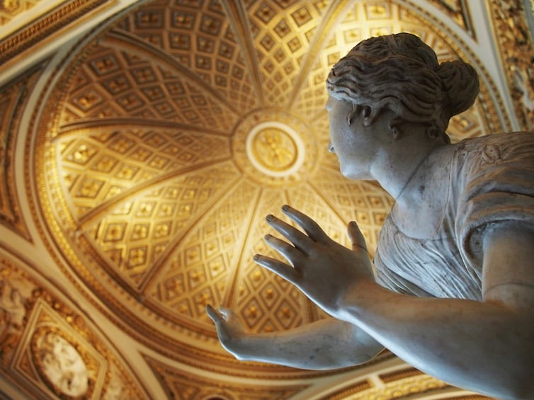 Marble statue and gold ceiling of the Uffizi Museum