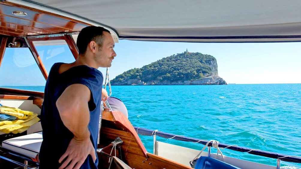 Person on a boat looks out on the waters of Cinque Terra