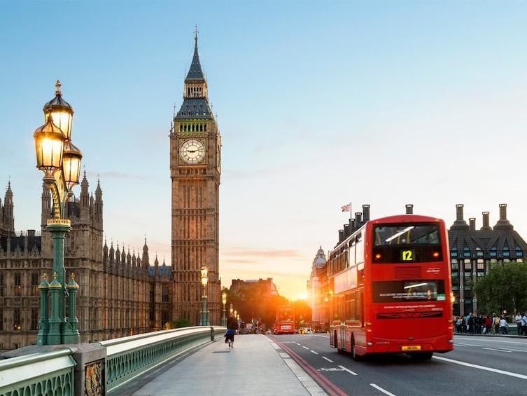 Red double-decker bus on the streets of London in the evening