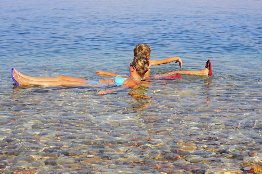Mother and son floating in the Dead Sea in Jerusalem