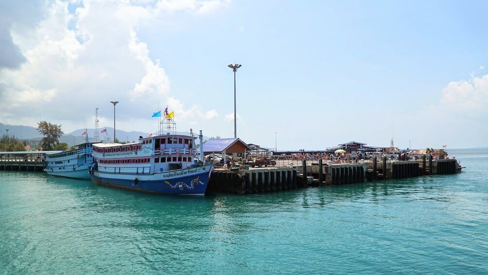 Multilevel boats docked at pier in Thailand