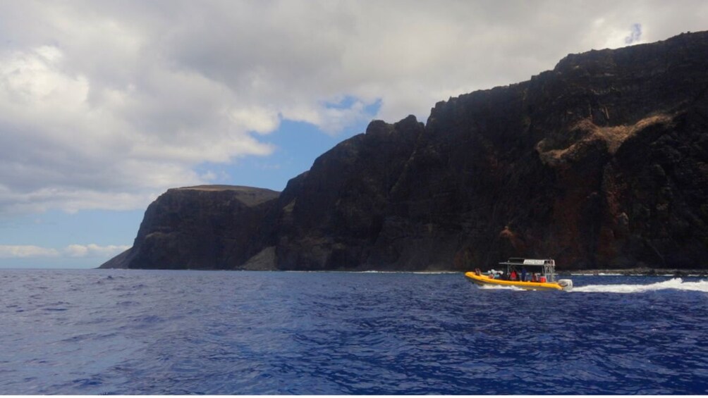 Small boat on ocean with Lanai, Hawaii in the background