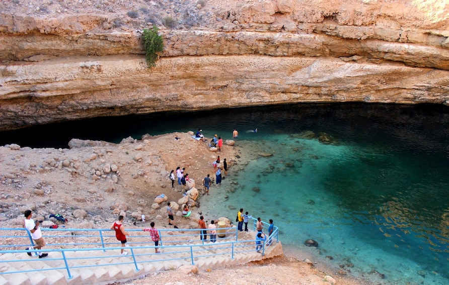 Tour group walking down to lake in Oman