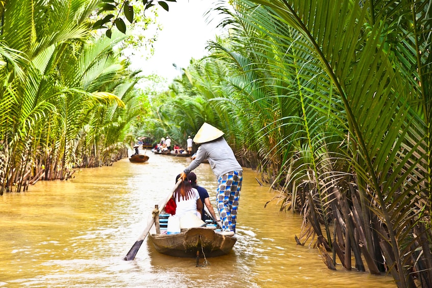 Wooden boats floating down the Mekong Delta 