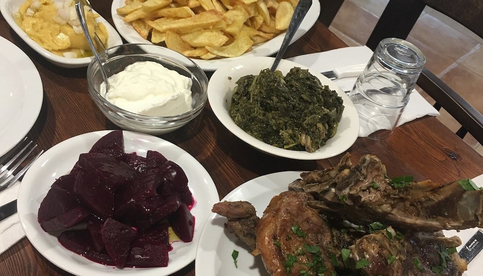 Dinner table with beets, lamb and vegetables
