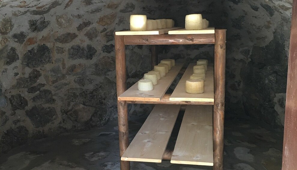 Cheese on cooling rack in stone room