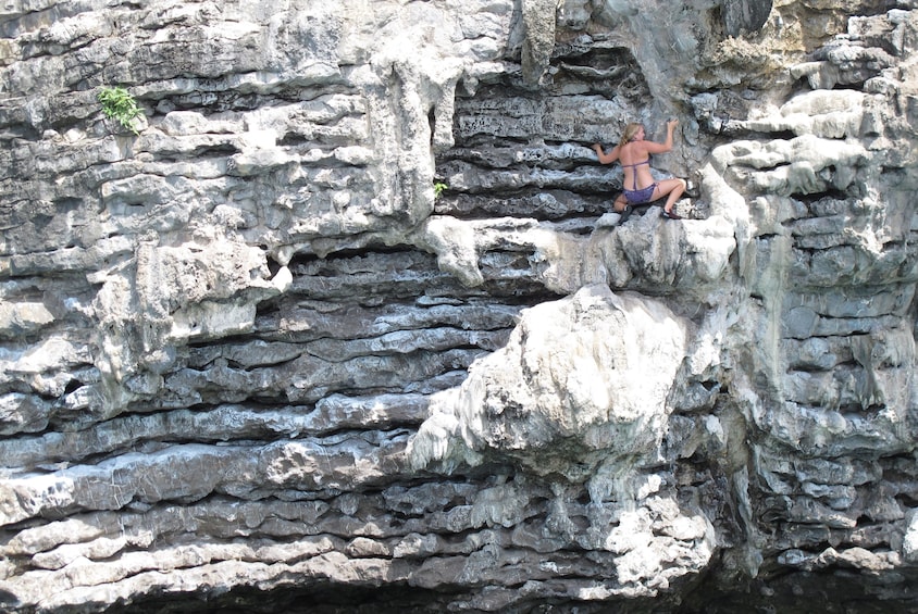 Woman rock climbing at Railay Beach