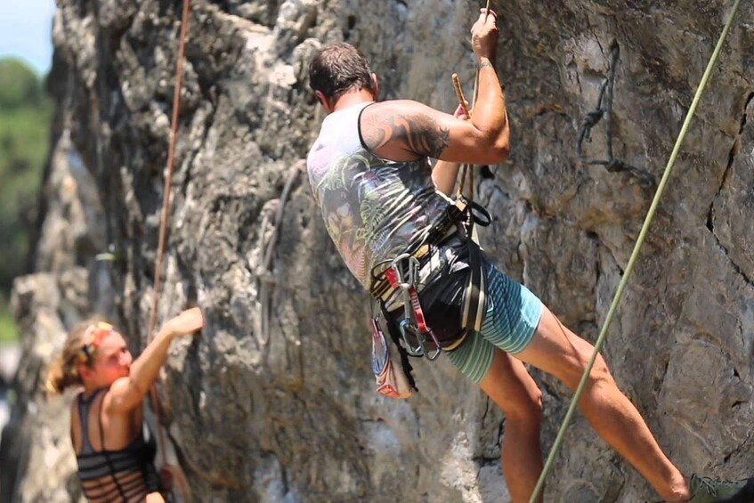 Couple on a rock climbing course at Railay Beach