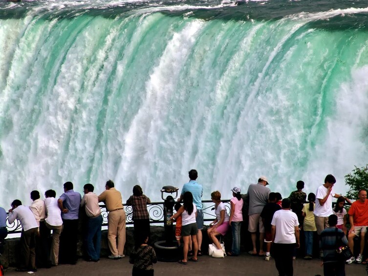 Tourists at balcony near top of Niagara Falls