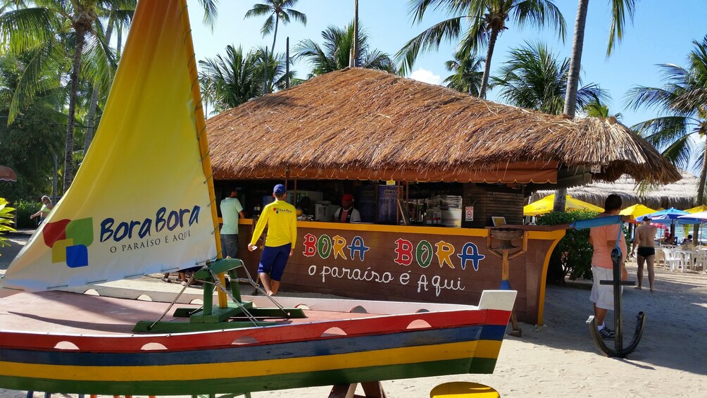 Boat and food stand on Carneiros Beach