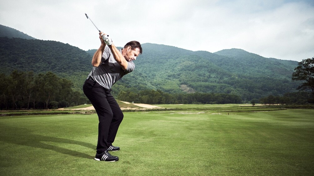 Man golfing at a golf club in Vietnam