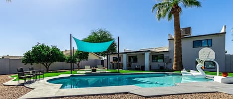 Private pool, poolside hoop, fire pit, outdoor canopy area with sun loungers. Outside patio with BBQ, mini fridge, and lounge area.