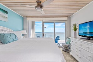 Retreat to this serene bedroom featuring a plush king bed, stylish decor, and a flat-screen TV for entertainment. Wake up to natural light and glimpses of the ocean, creating a perfect blend of comfort and coastal charm.