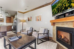 Vacation Rentals in Park City at Bear Hollow Lodges 4102: Living room with gas fireplace and private balcony access
