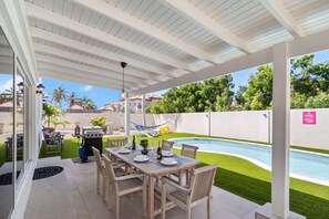 Resplendent Backyard Area of the 5BR house in Noord Aruba - Offering Dining Area - Lush Pool Views - BBQ Grill Available