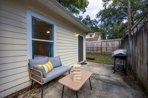 Outside area with settee, jengga and bbq grill